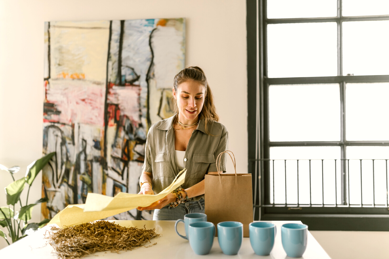  A Woman Packing Mugs